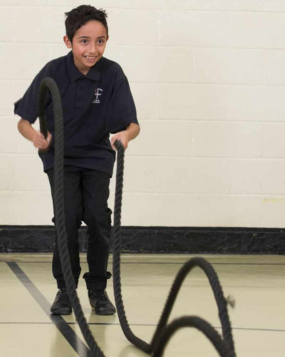 Boy doing battle rope exercise
