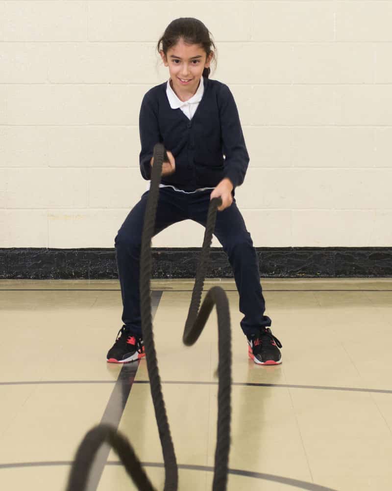 girl exercising with kidfit junior battle rope