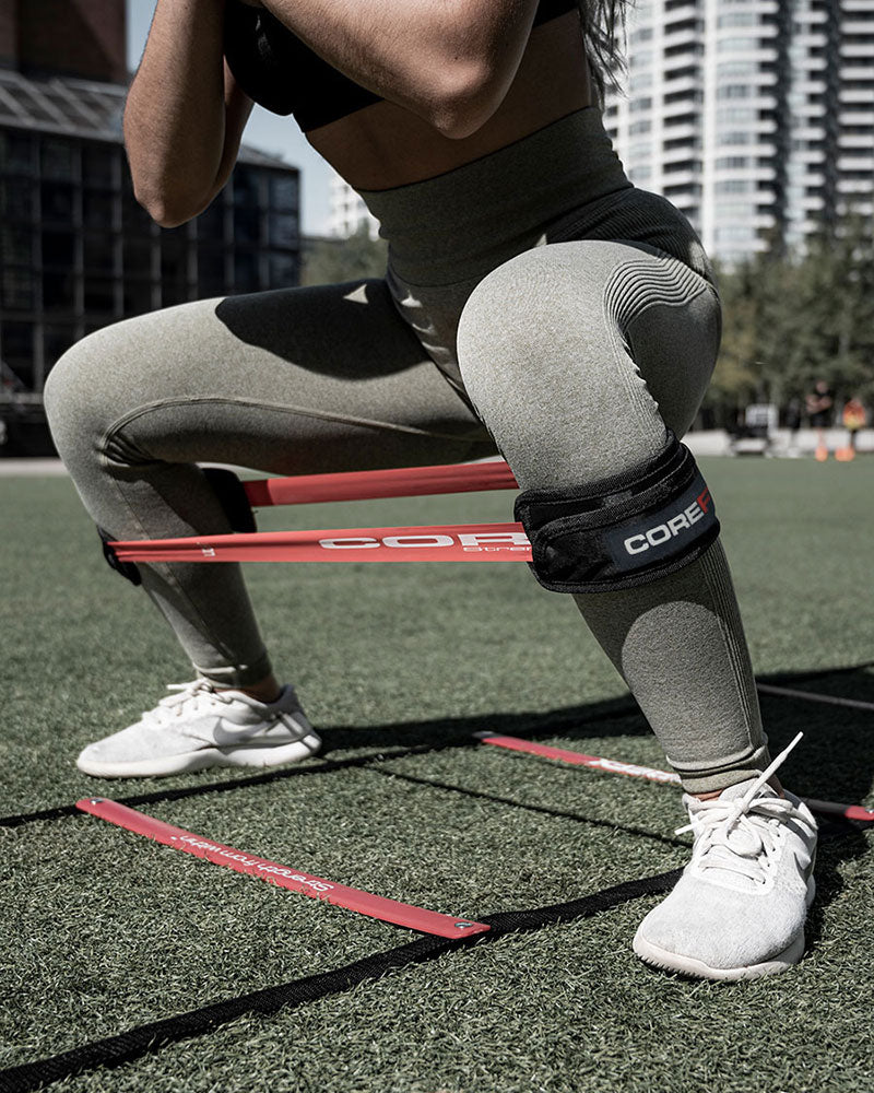 female athlete performing agility squats with the COREFX resistance loop sleeve