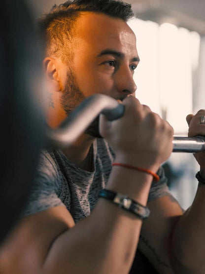 male in the gym with EZ curl bar