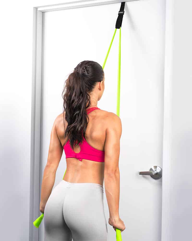 Woman doing tricep pulldowns with Flat Band and Door Anchor