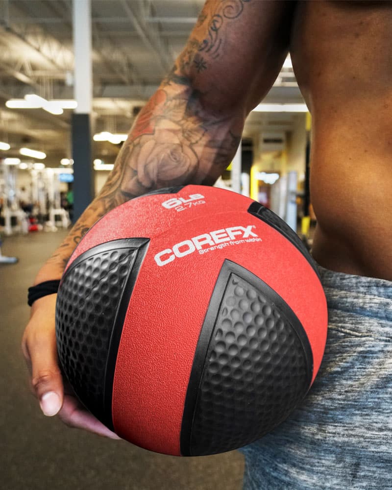 Male holding medicine ball