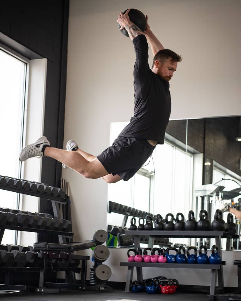 Male jumping with COREFX Slam Ball