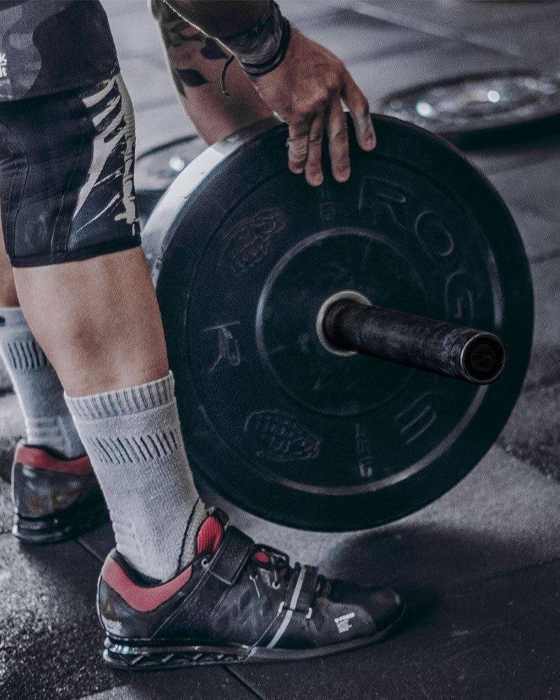 stacking bumper plates on the 45ln training barbell
