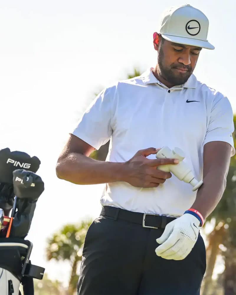 Golfer with Hypervolt Go 2 and holster in golf bag