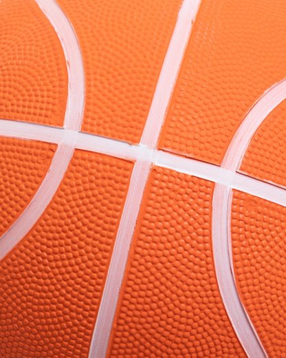close up of textured grip on orange playground basketball