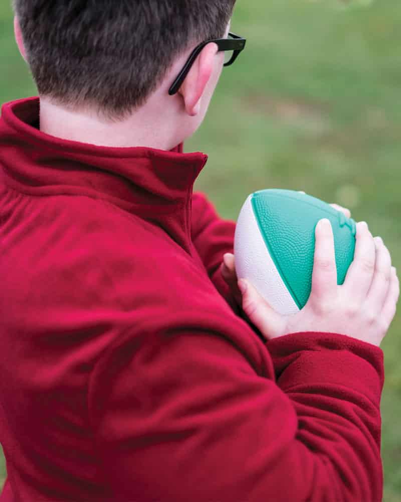 Boy using Mini Coated Foam Footballs