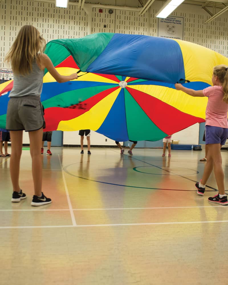 multi-coloured parachute in gym class