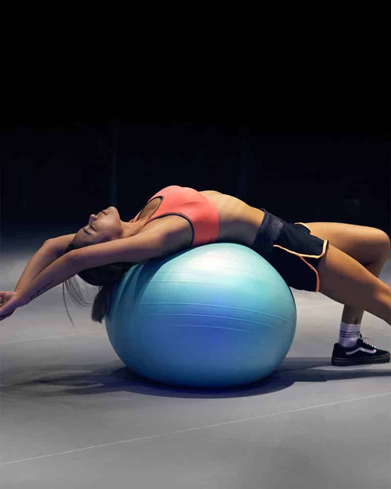 Woman stretching on stability ball