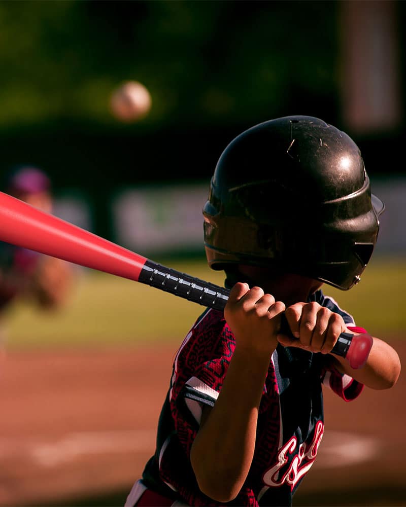 school red plastic baseball bat from sports kit