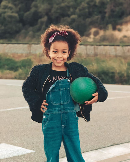 Girl holding green playground ball