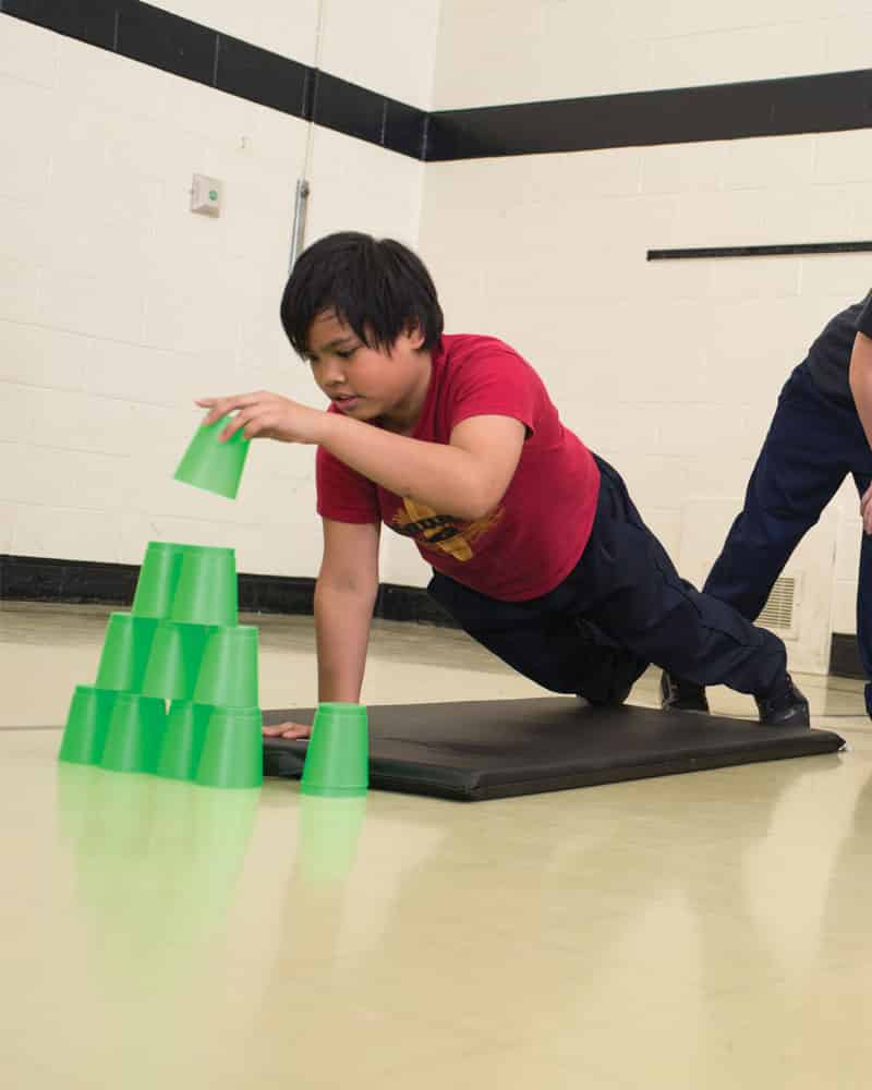 Boy Playing With Stacking Cups Green