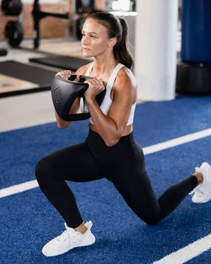 Female athlete using YBell Pro as in gym