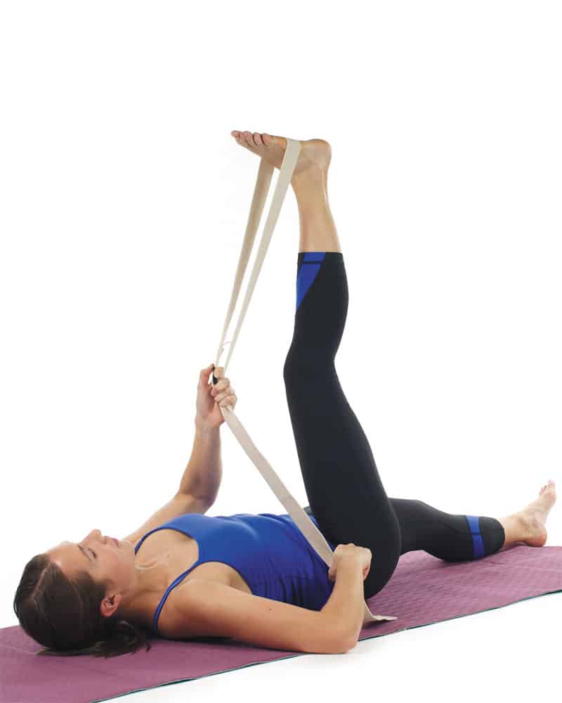 Woman stretching with yoga strap