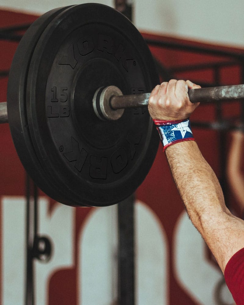 Athlete lifting barbell with York Rubber Bumper Plates